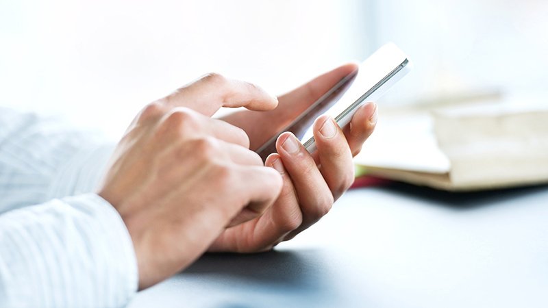 persons hands ready to tap smartphone screen