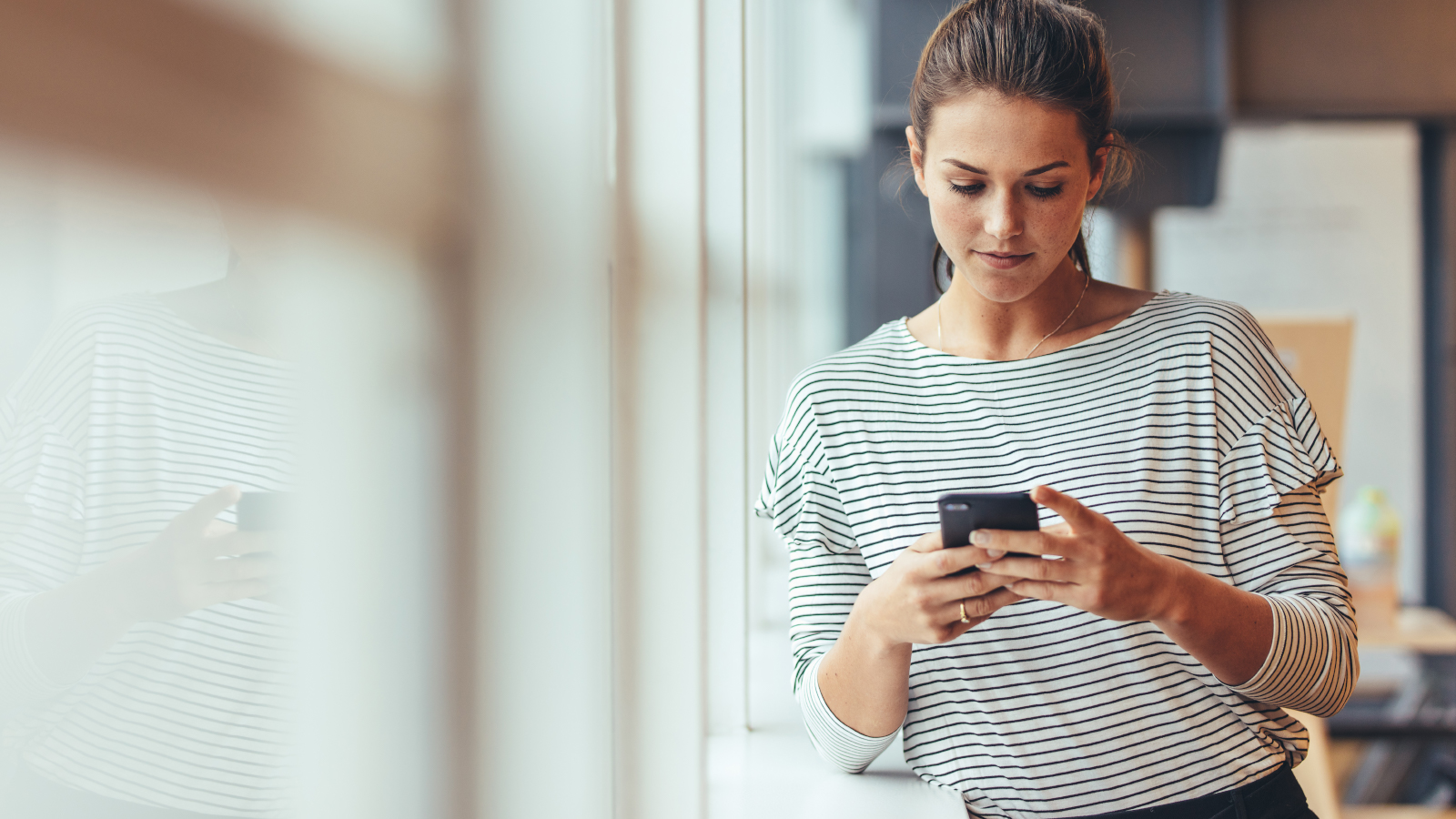 woman checking alerts on her mobile phone