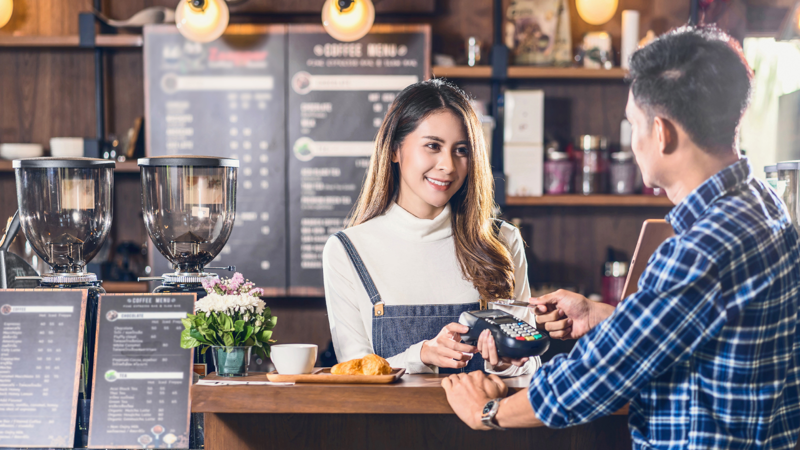 man paying for coffee at coffee shop