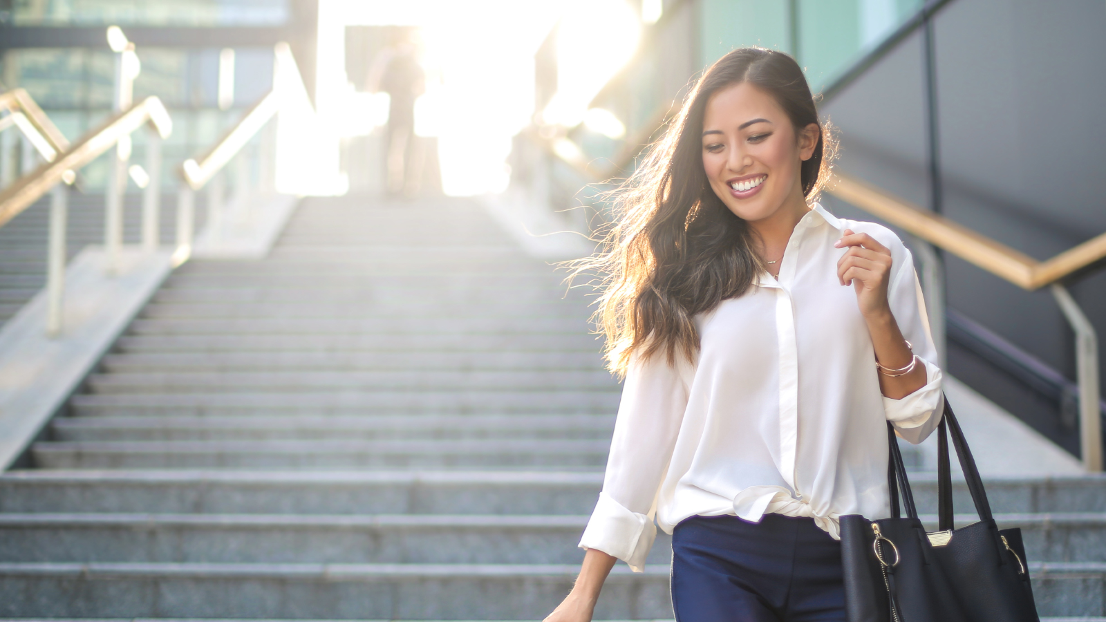 business woman walking down steps outside