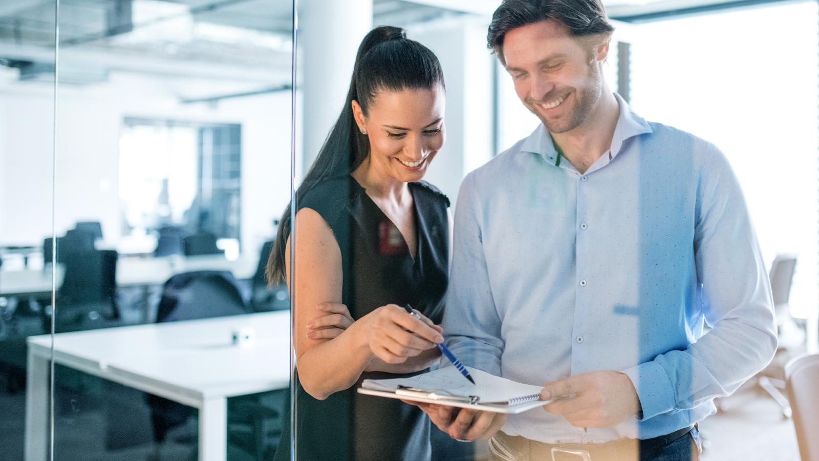 business colleagues look at paperwork together