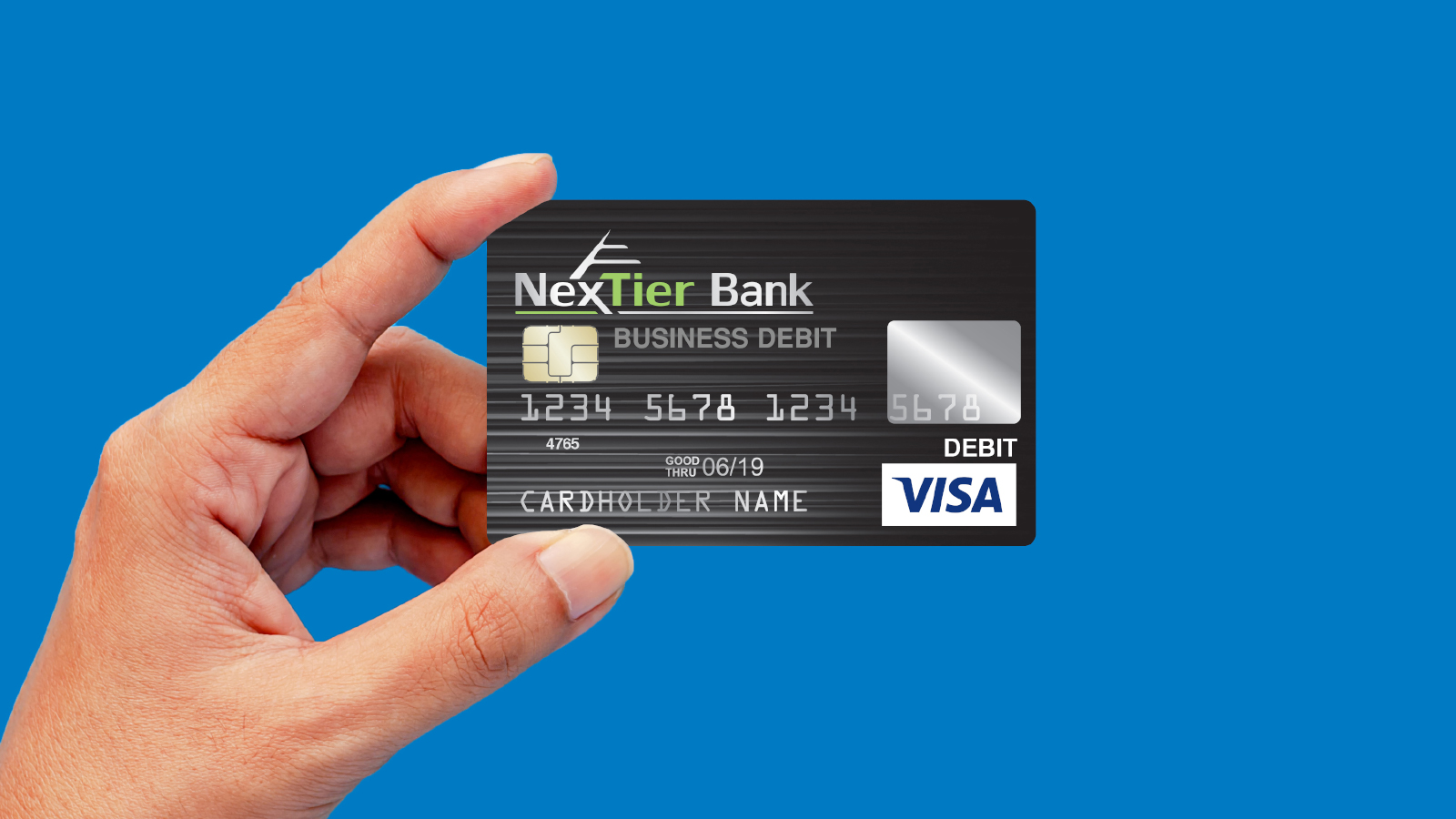 hand holding up NexTier business debit card.