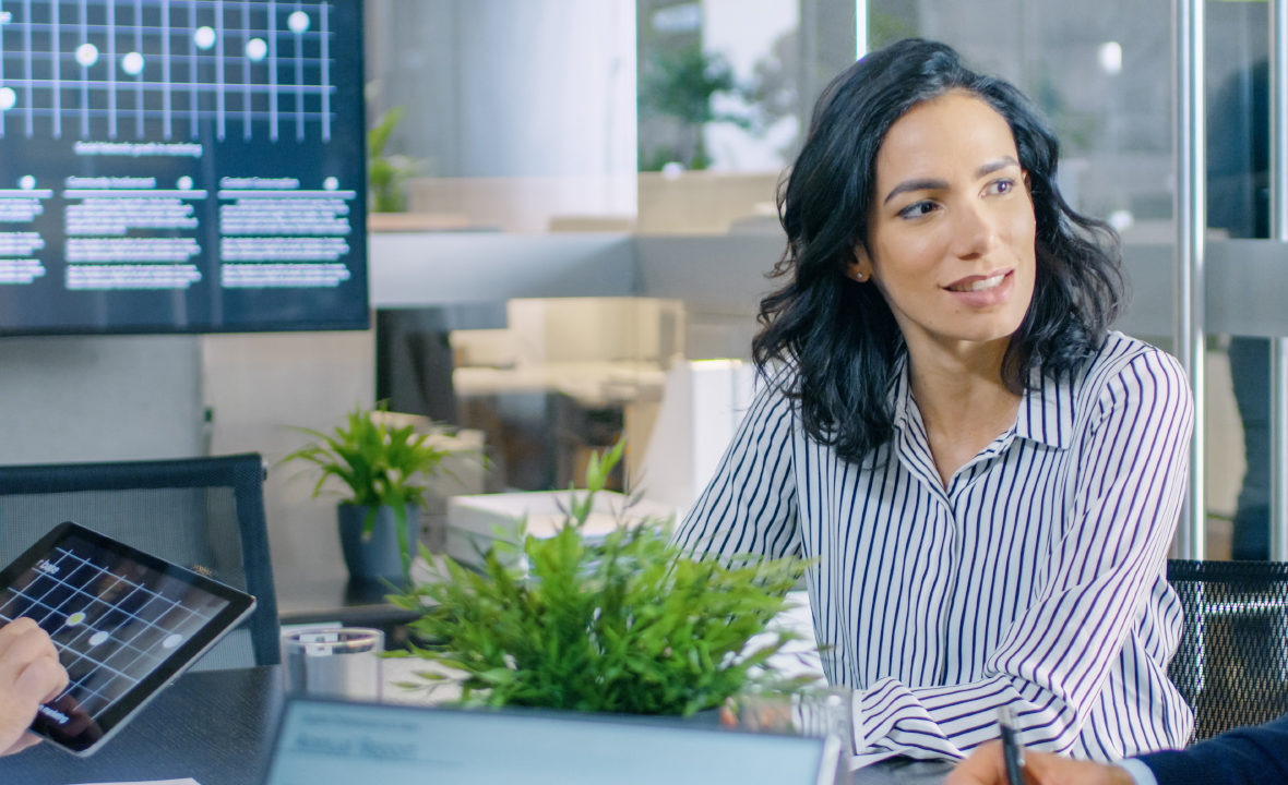 business team meeting with focus on a woman who is talking