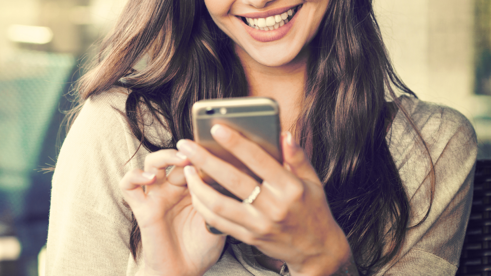 girl looking at phone screen smiling