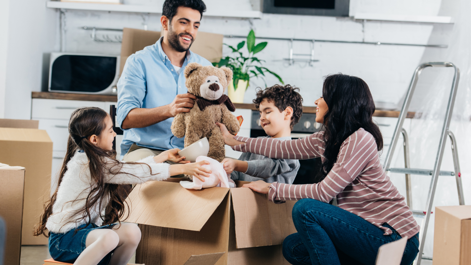 family unpacking boxes in new home