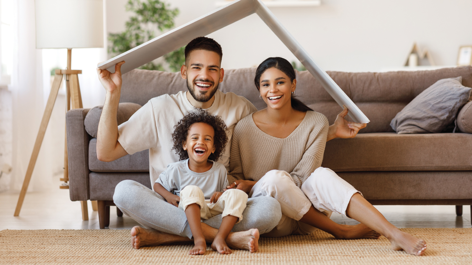 family of three playing in new house