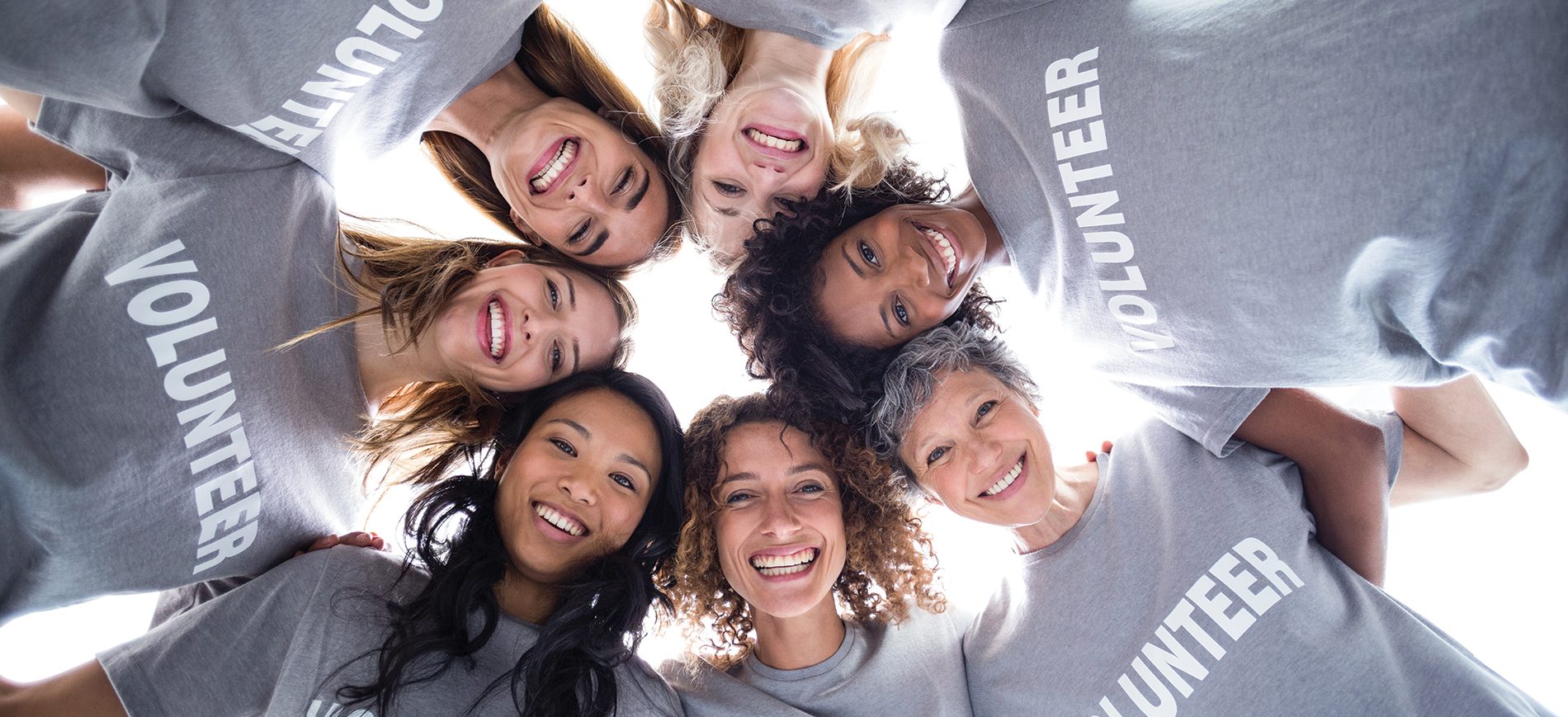 Women volunteers in circle smiling