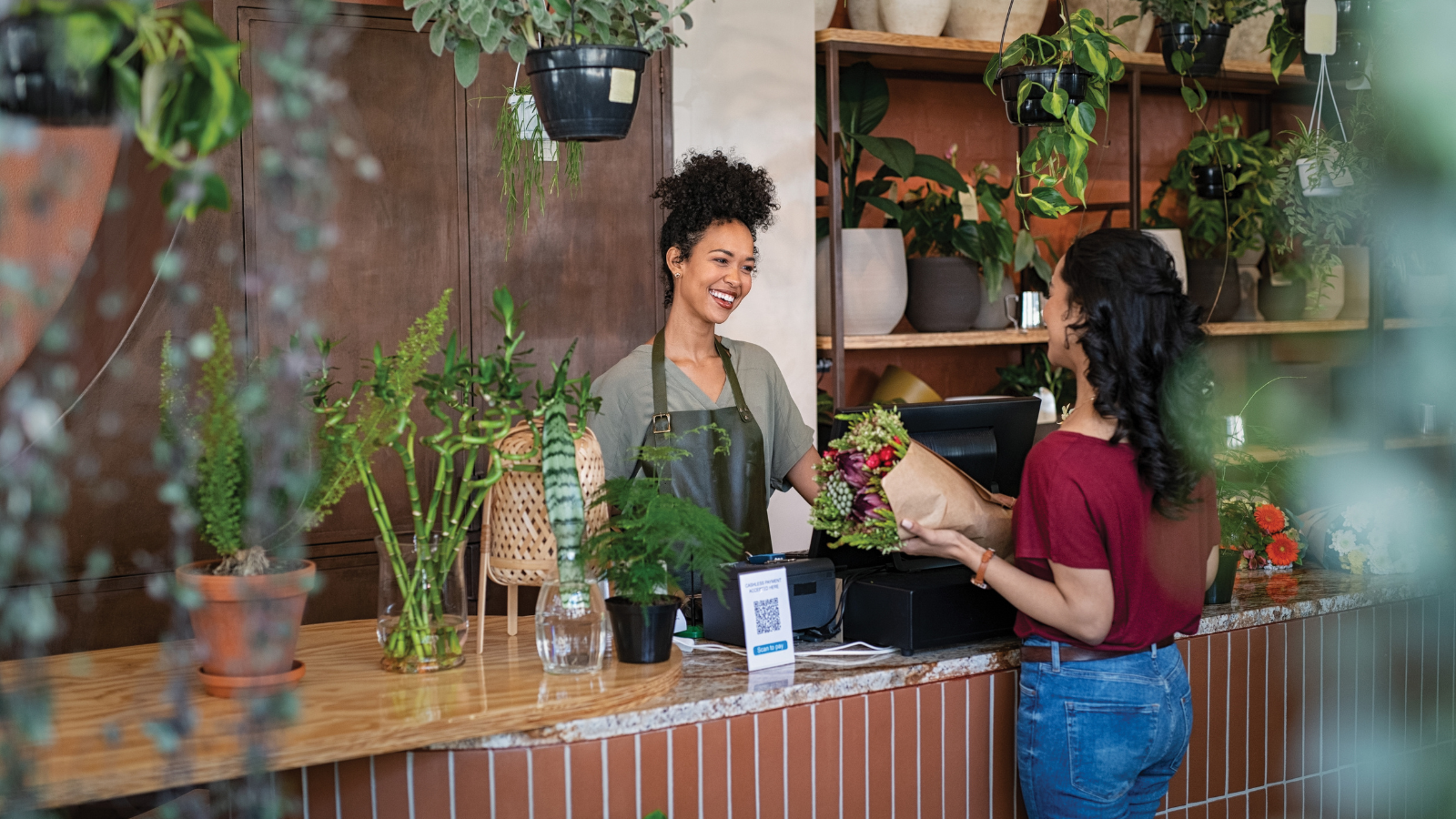 customer paying a florist for flowers