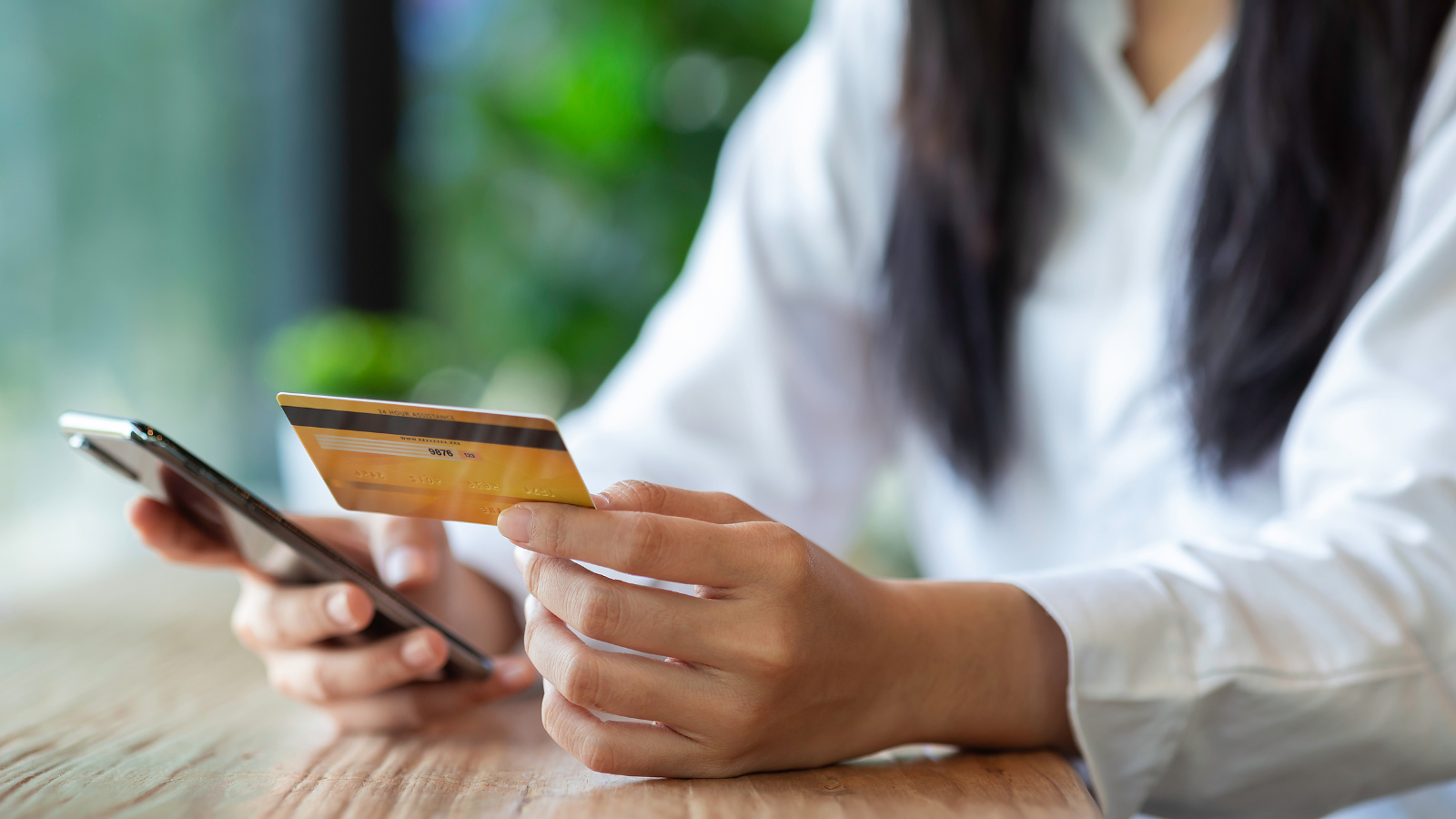 someone using a personal credit card to make a purchase